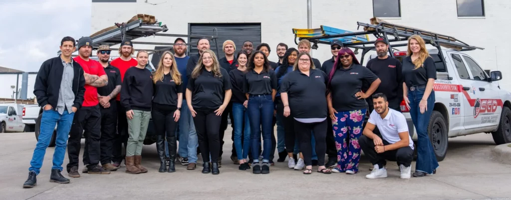 Supreme Garage Door Repair team standing together outside company trucks in Dallas, Texas